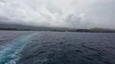 Transport ferry crossing the ocean from Bohol to Camiguin Island Philippines during storm and rain, dramatic maritime travel and tourism adventure