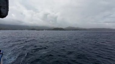 Transport ferry crossing the ocean from Bohol to Camiguin Island Philippines during storm and rain, dramatic maritime travel and tourism adventure