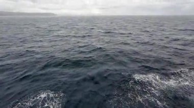 Transport ferry crossing the ocean from Bohol to Camiguin Island Philippines during storm and rain, dramatic maritime travel and tourism adventure