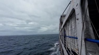 Transport ferry crossing the ocean from Bohol to Camiguin Island Philippines during storm and rain, dramatic maritime travel and tourism adventure
