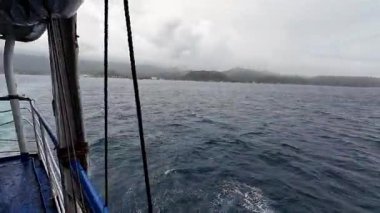 Transport ferry crossing the ocean from Bohol to Camiguin Island Philippines during storm and rain, dramatic maritime travel and tourism adventure