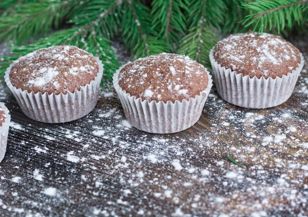 Three Christmas cakes on winter snowbound wooden background, fir