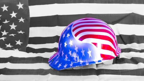 9/11 American flag construction helmet given to people working on the site. sitting on a black & white American flag