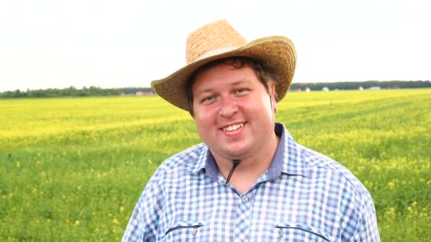 Portrait of a happy farmer in front of his field — Stock Video