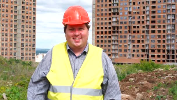 Contremaître constructeur ou architecte travaillant sur le chantier debout tout en riant et en souriant à la caméra — Video