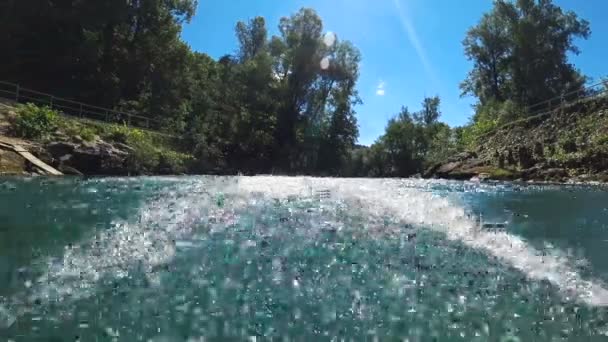 Wide angle of blue clear water river flowing with power from the camera — Stock Video