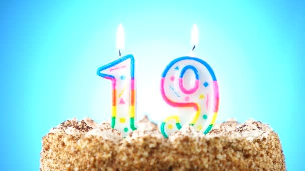 Birthday cake with a burning birthday candle. Number 19. Background changes color — Stock Video