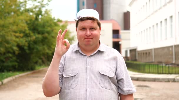 Young muslim man in city giving ok sign — Stock Video