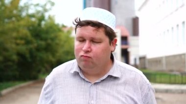 Yakışıklı Müslüman adam başını açık havada sallayarak hayır diyor. Yakın çekim