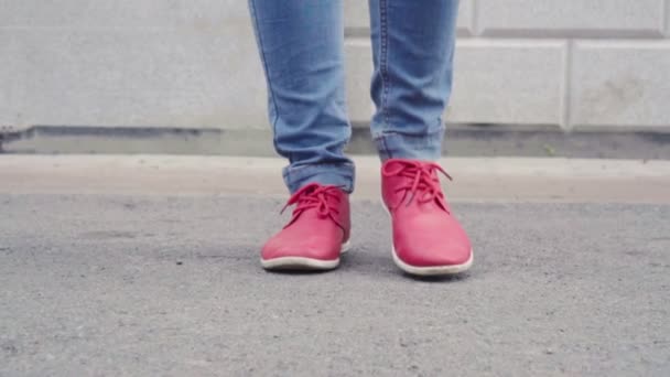 Женщина гуляет по городу в дневное время осенью, крупный план ее красные туфли, прогуливаясь — стоковое видео