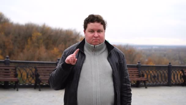 Portrait of fat man and gesturing a no sign. Closeup serious guy raising finger up saying oh no you did not do that. — Stock Video