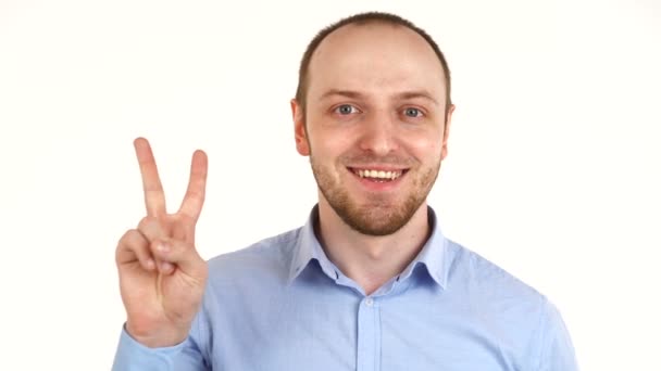 Handsome european man looking at camera and holding victory sign. — Stock Video
