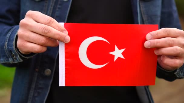 Man holding Turkish flag outdoors. Independence Day, or national holidays concepts — Stock Video