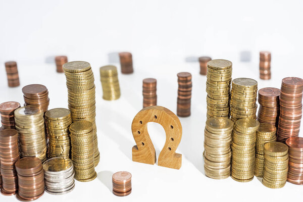 Abstract photo. Horseshoe on euro coins. Isolated on white background.