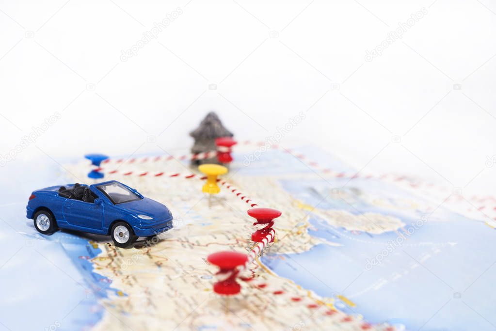Abstract idea of rent a car. Small car on map. Abstract travel photo.
