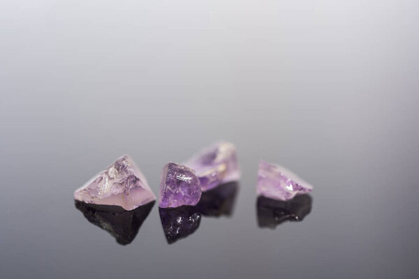 Amethyst small stones. Gems isolated on white background.