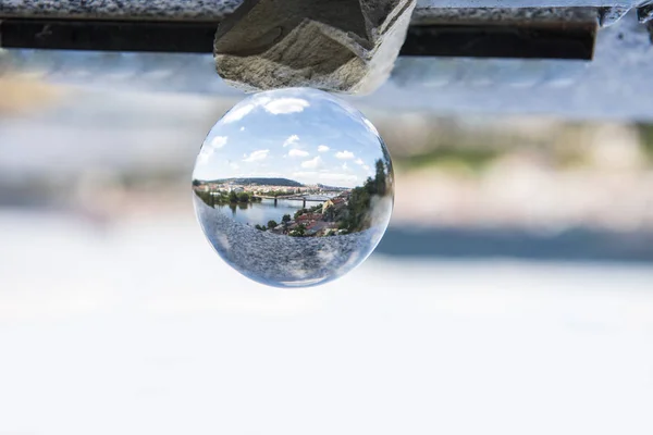 Panoramic view of Prague through the glass ball. Abstract city view photo. — Stock Photo, Image