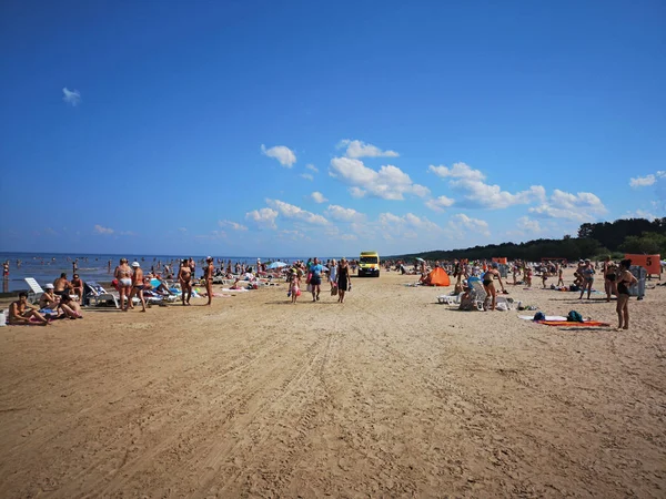 July 28, 2019. Beach in Vecaki, Latvia.  Hot sunny summer Day +32C. Ambulance on the beach. — Stock Photo, Image