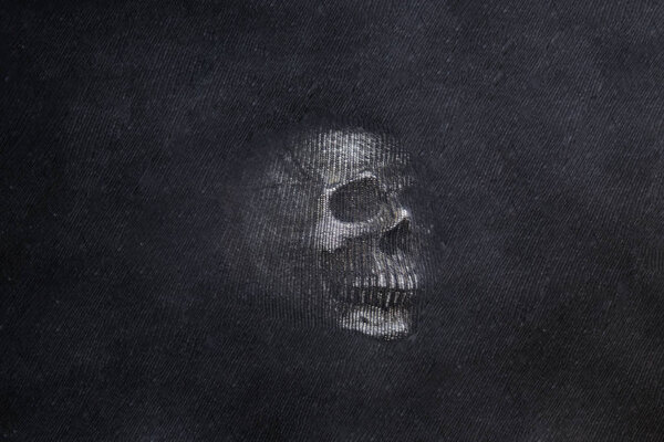 Human Skull on black textured background. Abstract photo.