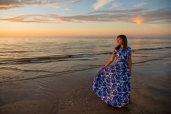 Beautiful young woman relaxing at sunset