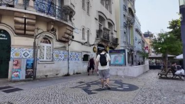 Lisbon Portugal summer POV walking street photo with tiled walls colorful travel vibe
