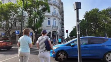 Lisbon Portugal summer POV walking photo with cobblestone alleys tiled facades bright sun