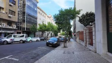 Summer Lisbon POV walking photo with traditional buildings sunny tourism vibe