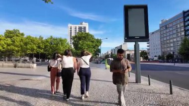 Sunny summer Lisbon POV travel walking scene with cobblestone architecture