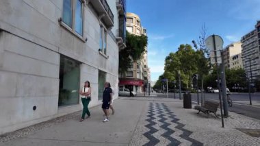Lisbon Portugal summer POV cobblestone streets with architecture and sunny travel