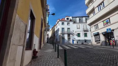 Sunny Lisbon Portugal POV walking scene with colorful facades cobblestones European travel
