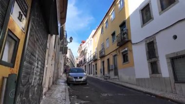 POV Lisbon old streets summer day with traditional Portuguese houses and urban lifestyle