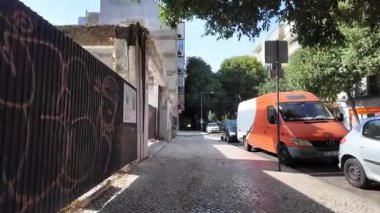 Summer walk Lisbon POV through old historic streets with bright European vibe