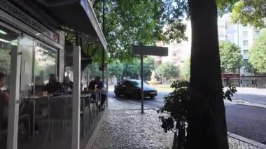 Summer POV Lisbon walking scene with historic European city architecture tourism