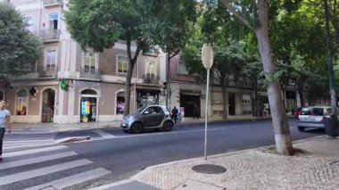 POV stroll through Lisbon old streets in summer with traditional architecture and sun