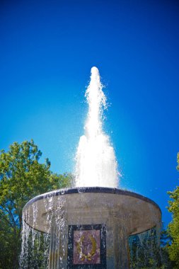 Parkta gökyüzüne karşı birkaç boynuzu olan eski çeşme.