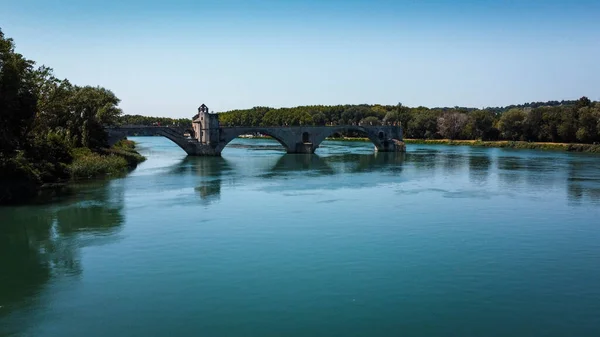 Broken bridge Saint-Bnzet in the city of Avignon in Provence. famous Avignon bridge over the Rhone depicted in paintings, poems, stamps. architecture seen from a drone with its arches. Historic bridge that attracts tourists from all over Europe.