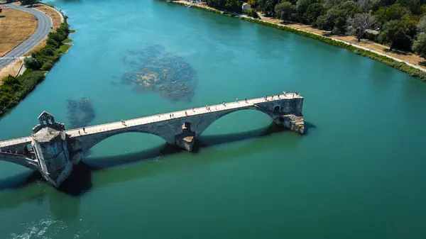 Broken bridge Saint-Bnzet in the city of Avignon in Provence. famous Avignon bridge over the Rhone depicted in paintings, poems, stamps. architecture seen from a drone with its arches. Historic bridge that attracts tourists from all over Europe.