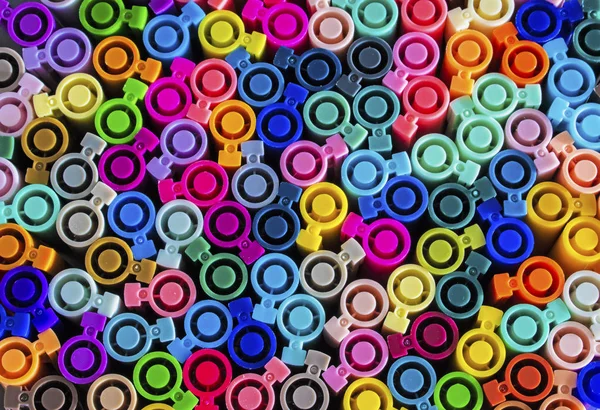 Set of several colored markers of different colors, the top view of the covers. Abstract colorful background from multi-colored caps for plastic pens