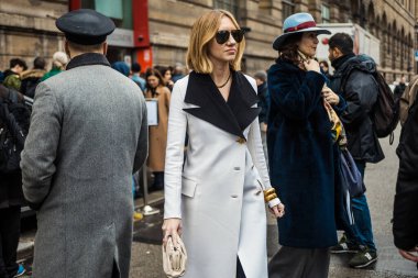 PARIS, FRANCE - MARCH 02, 2020: Lisa Aiken wears sunglasses, white coat with a large black collar and brass buttons seen outside GIAMBATTISTA VALLI show, during Paris Fashion Week Womenswear Fall/Winter'20-21. clipart