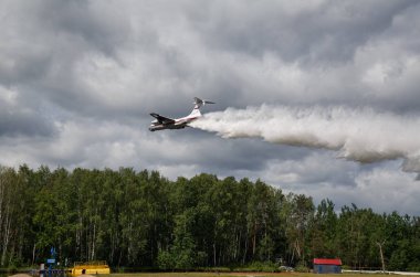 NOGINSK/ RUSSIA - JUNE 06, 2018. Aircraft Ilyushin IL-76TD demonstrates aerial firefighting during the international exhibition Complex Safety-2018. Noginsk Rescue Center, Moscow region, Russia. clipart
