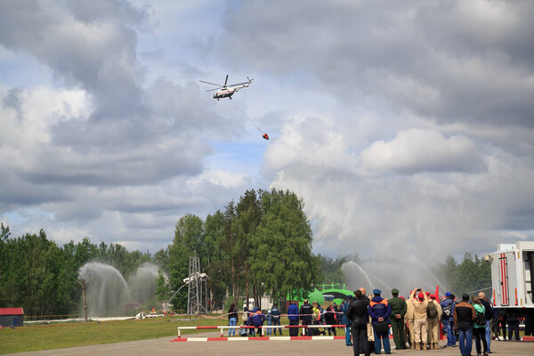NOGINSK/ RUSSIA - JUNE 06, 2018. Helicopter with a bucket demonstrates aerial firefighting during the international exhibition Complex Safety-2018. Noginsk Rescue Center, Moscow region, Russia.