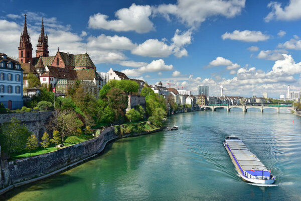 Old town Grossbasel with Basler Muenster Cathedral on the banks of the Rhine river on a sunny spring day. City of Basel, Switzerland, Europe.