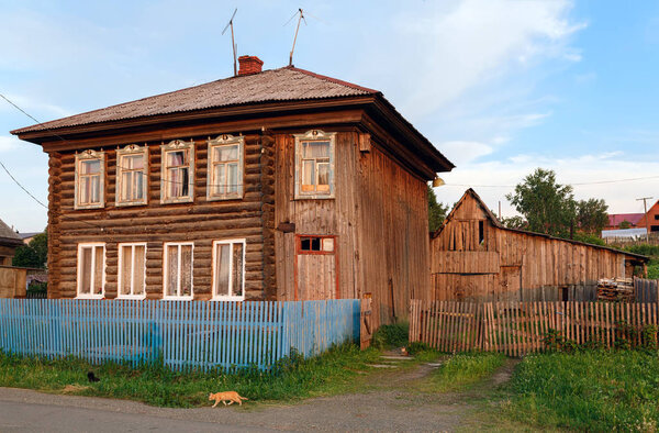 Dilapidated wooden residential house. Village of Visim, Sverdlovsk region, Urals, Russia