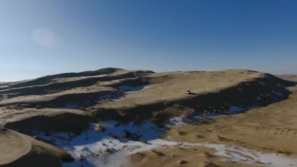 Luftaufnahme von Geländewagen, die sich im Winter durch die verschneite Wüste bewegen. Westkasachstan, Halbinsel Mangyshlak. — Stockvideo