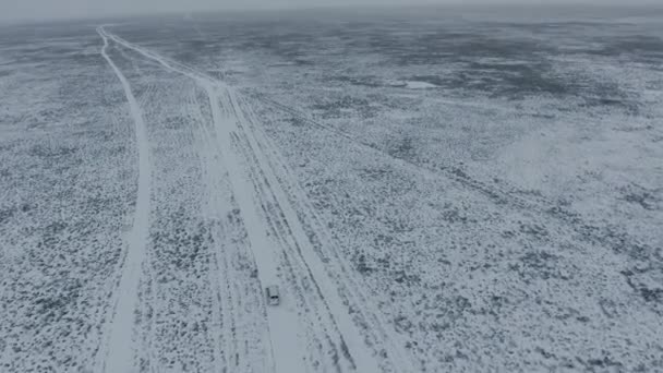 Amazing aerial view of snow-covering sandy mountains in Western Kazakhstan, Mangyshlak Peninsula. Desert in the snow. — Stock Video