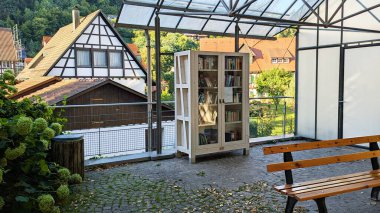 Bench ve Geleneksel Mimari ile Cobblestone Terasında Büyüleyici Açık Alan Kitap Takas Klübesi