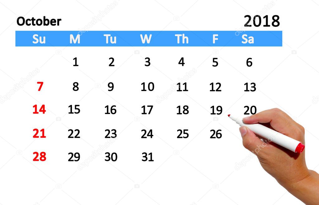 Hand highlighting date on calendar