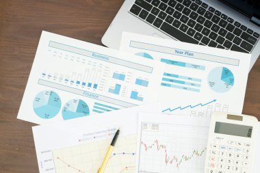 Masa başında iş raporu ve dizüstü bilgisayar