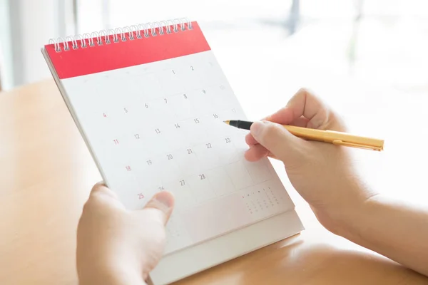 Woman hand carrying calendar and pointing on it by pen — 스톡 사진