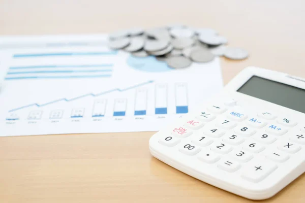 Calculator and stack of coins — Stock Photo, Image